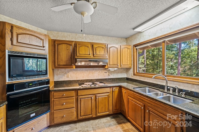 kitchen with sink, black appliances, a textured ceiling, and ceiling fan