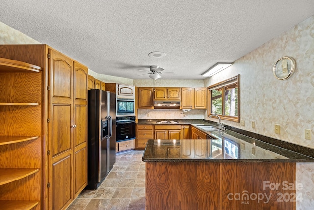 kitchen with kitchen peninsula, ceiling fan, a textured ceiling, black appliances, and sink