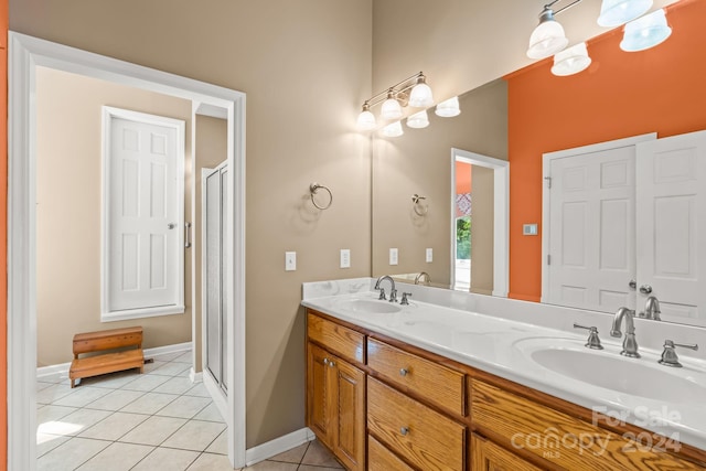 bathroom featuring vanity, a shower with shower door, and tile patterned flooring