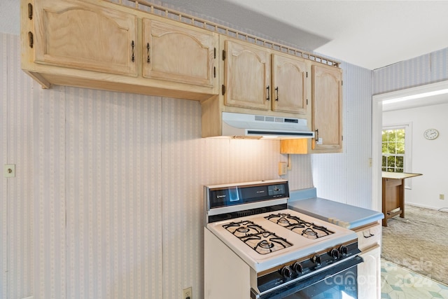 kitchen with white gas range and light brown cabinets