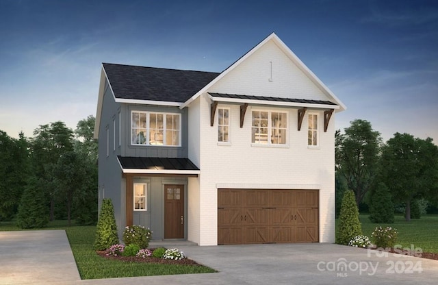 view of front of home featuring a front yard and a garage