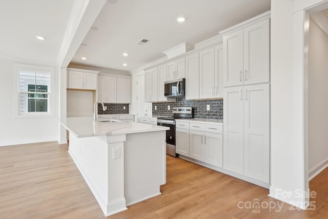 kitchen featuring light wood-style floors, visible vents, appliances with stainless steel finishes, and a sink