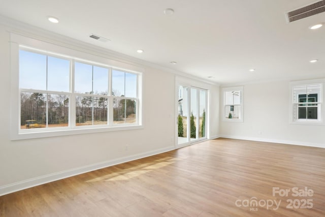 821 Terra Dr, Tega Cay, SC 29708 - spare room with light wood-style flooring, visible vents, and ornamental molding