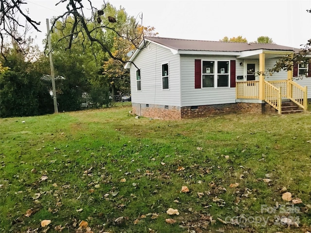 view of side of property with a yard