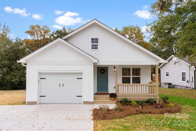 view of front of property with central AC, a porch, and a garage