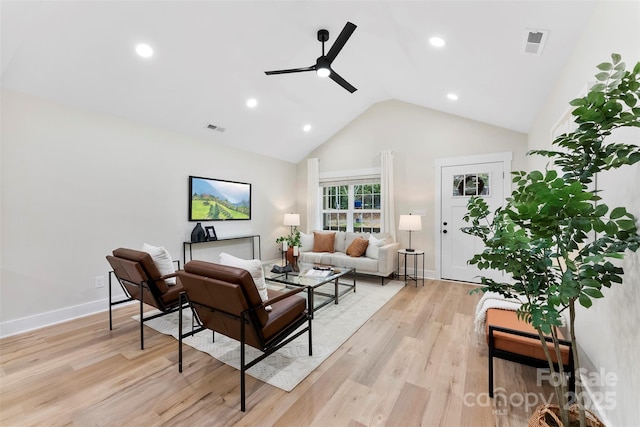 living room featuring ceiling fan, high vaulted ceiling, and light hardwood / wood-style floors