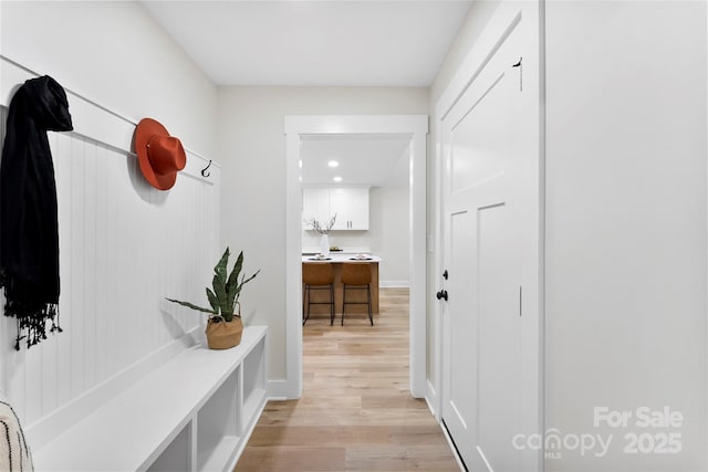 mudroom with light hardwood / wood-style flooring