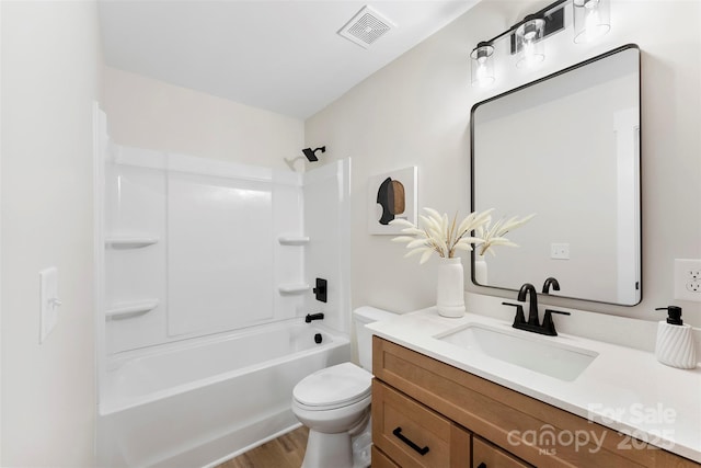 full bathroom featuring washtub / shower combination, vanity, wood-type flooring, and toilet