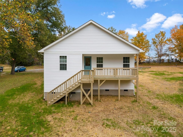 rear view of property featuring a lawn