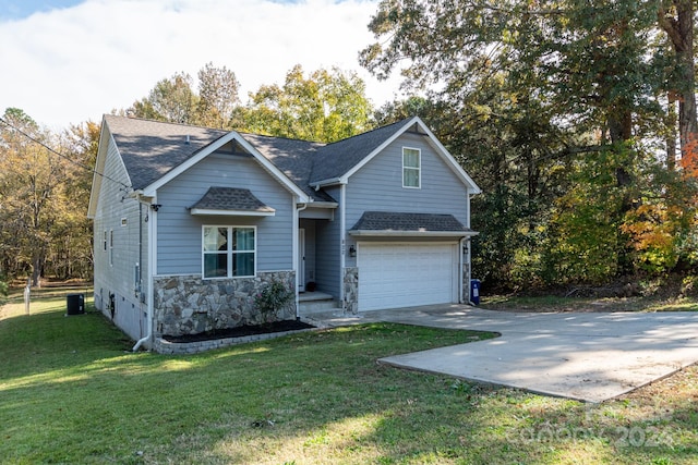 view of front of property with a front yard and a garage