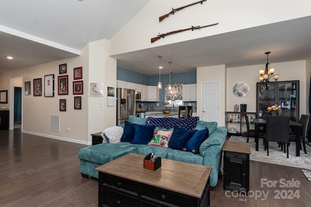 living room with dark wood-type flooring and a chandelier