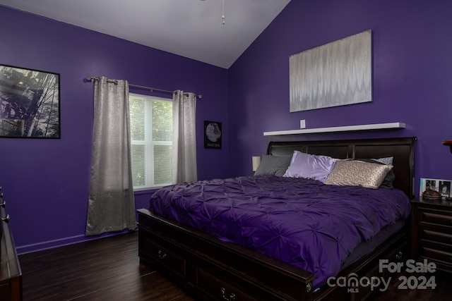 bedroom with vaulted ceiling and dark hardwood / wood-style floors