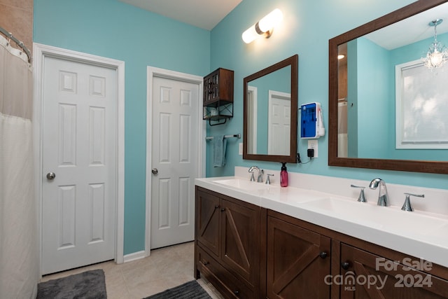 bathroom featuring vanity, a notable chandelier, and tile patterned floors