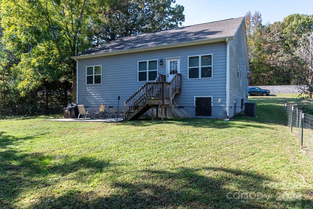 back of house with central AC and a yard