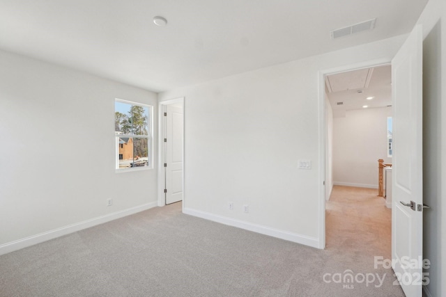 809 Terra Dr, Tega Cay, SC 29708 - unfurnished bedroom with baseboards, visible vents, light carpet, and attic access