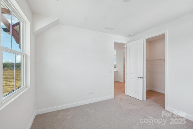 809 Terra Dr, Tega Cay, SC 29708 - unfurnished bedroom with a spacious closet, visible vents, baseboards, light carpet, and a closet