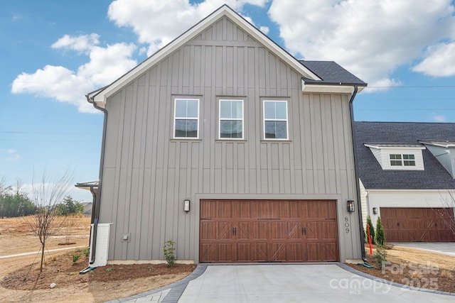 809 Terra Dr, Tega Cay, SC 29708 - view of front facade with a garage, roof with shingles, board and batten siding, and concrete driveway