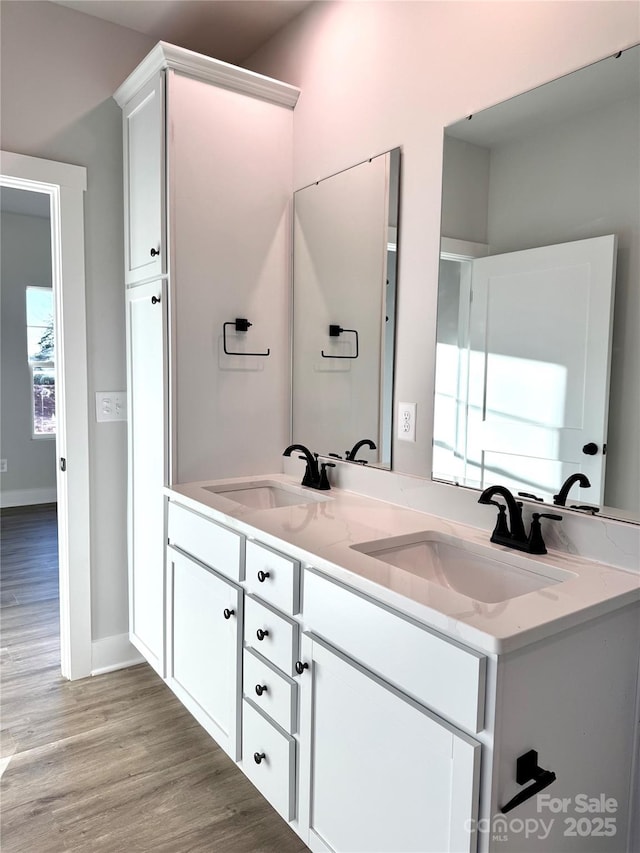 bathroom with plenty of natural light, hardwood / wood-style floors, and vanity