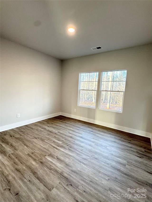 empty room with wood-type flooring