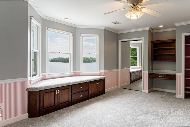 unfurnished room with ceiling fan, ornamental molding, and light carpet