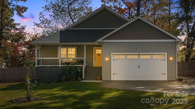 view of front of property with a porch, a garage, and a yard