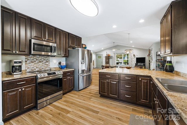 kitchen with stainless steel appliances, decorative light fixtures, and dark brown cabinets