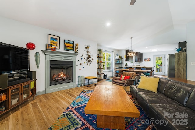 living room featuring lofted ceiling and hardwood / wood-style floors