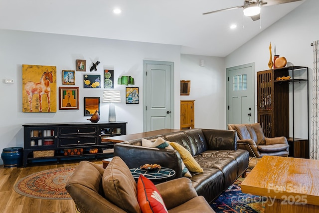 living room with ceiling fan, lofted ceiling, and hardwood / wood-style floors