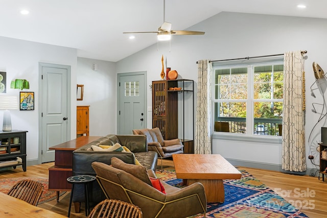 living room with vaulted ceiling, ceiling fan, and light hardwood / wood-style flooring