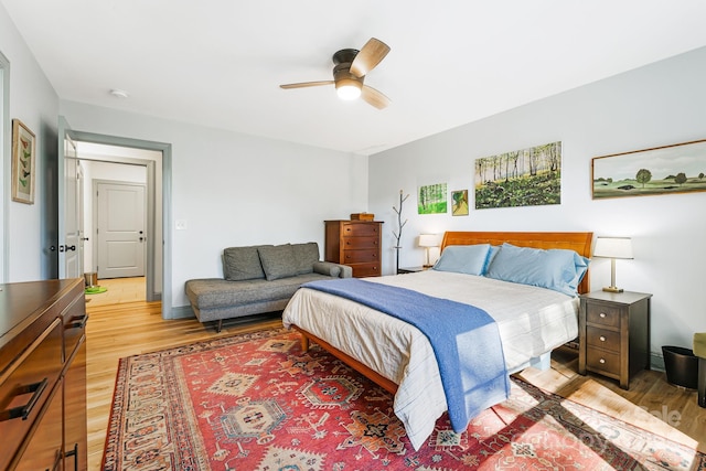 bedroom with ceiling fan and light hardwood / wood-style floors