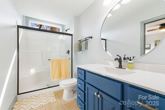 bathroom with an enclosed shower, vanity, tile patterned flooring, and toilet