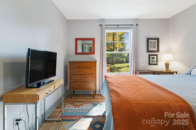 bedroom with hardwood / wood-style flooring