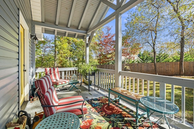 unfurnished sunroom with lofted ceiling with beams