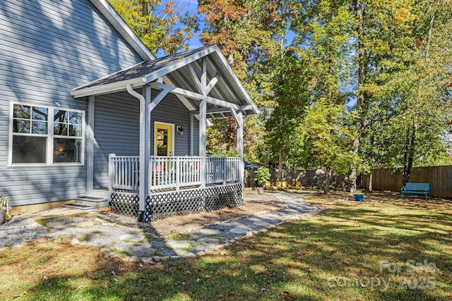 exterior space featuring a wooden deck and a lawn