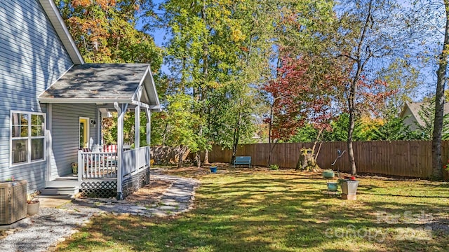 view of yard featuring central AC and a deck