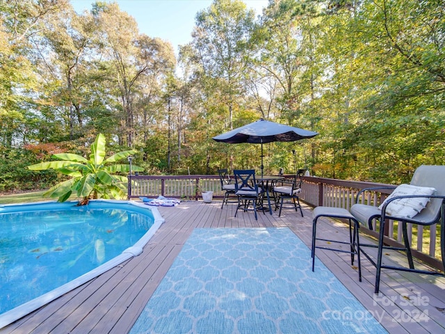 view of pool with a wooden deck