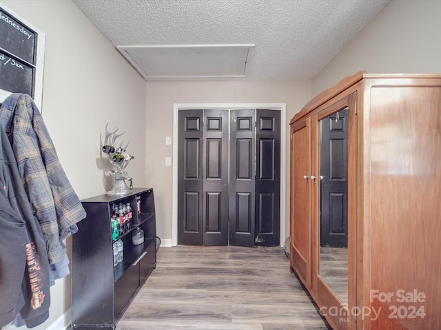 entryway featuring light hardwood / wood-style floors and a textured ceiling