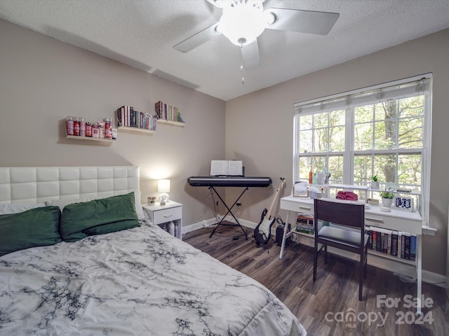 bedroom with dark wood-type flooring, ceiling fan, and a textured ceiling