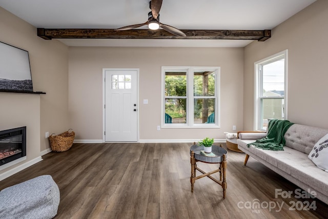 living room featuring beam ceiling, hardwood / wood-style flooring, and ceiling fan