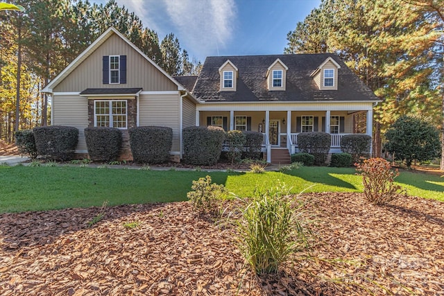 view of front facade featuring covered porch and a front lawn