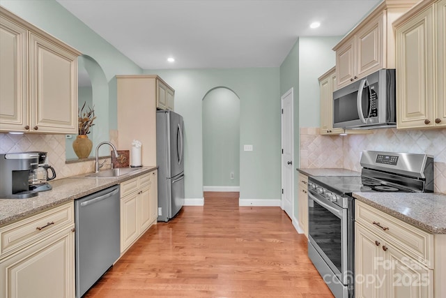 kitchen featuring sink, cream cabinets, and appliances with stainless steel finishes