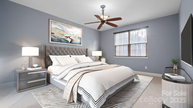 carpeted bedroom with ceiling fan and baseboards