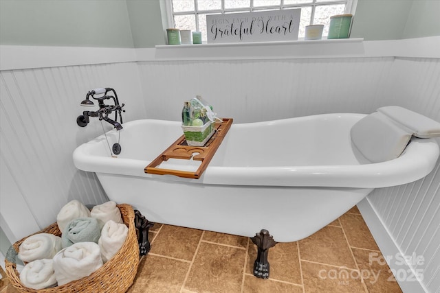 full bathroom featuring a freestanding bath and wainscoting