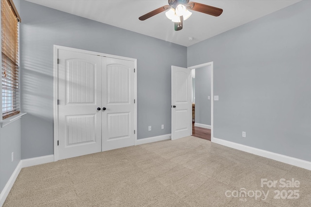 unfurnished bedroom with light carpet, a closet, and ceiling fan