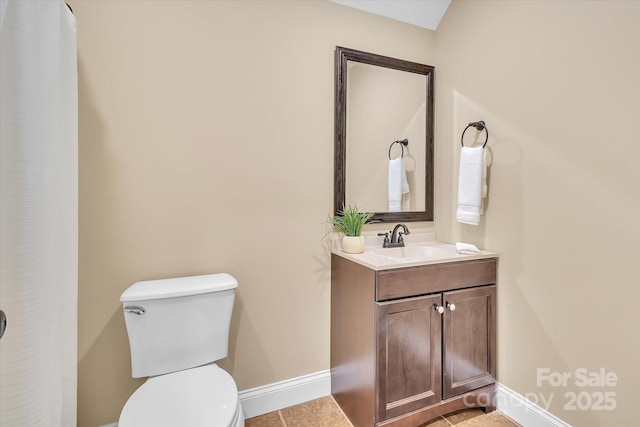 full bath with vanity, toilet, baseboards, and tile patterned flooring