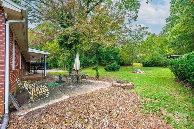 view of yard with a patio and a fire pit