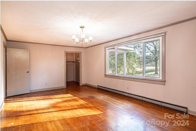 unfurnished bedroom featuring a closet, wood-type flooring, a baseboard radiator, a chandelier, and a textured ceiling