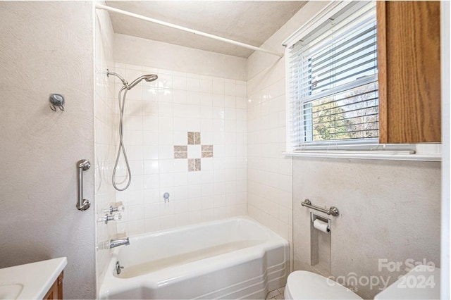 full bathroom with vanity, tiled shower / bath combo, and toilet