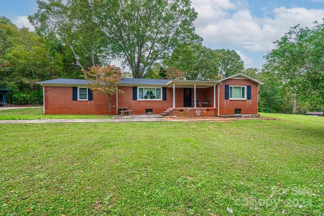 ranch-style house featuring a porch and a front lawn