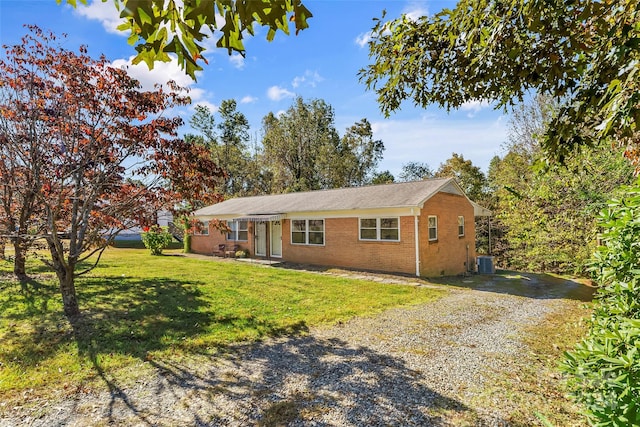 ranch-style house with central AC and a front yard